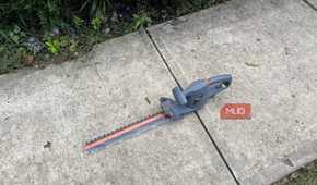 The sidewalk with a Scotts Corded Hedge Trimmer