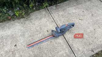 The sidewalk with a Scotts Corded Hedge Trimmer
