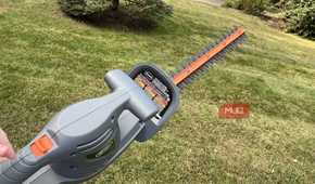 Scotts Corded Hedge Trimmer being held up over grass