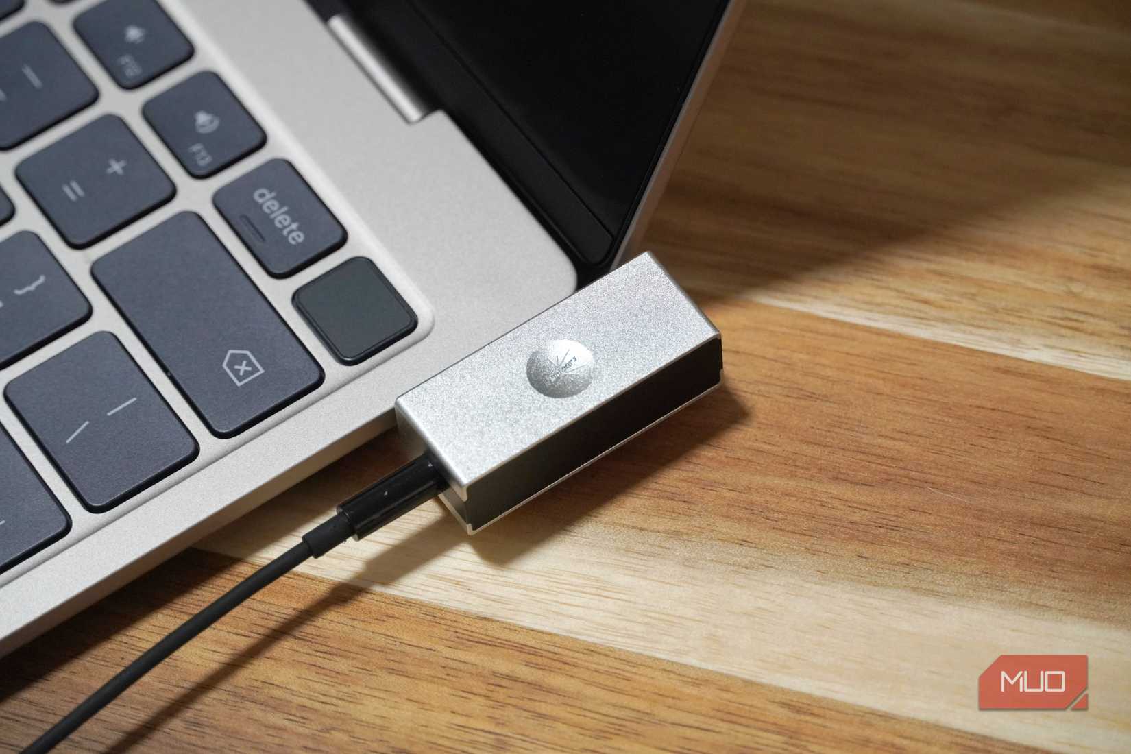 The USB-C DAC flush against a laptop.